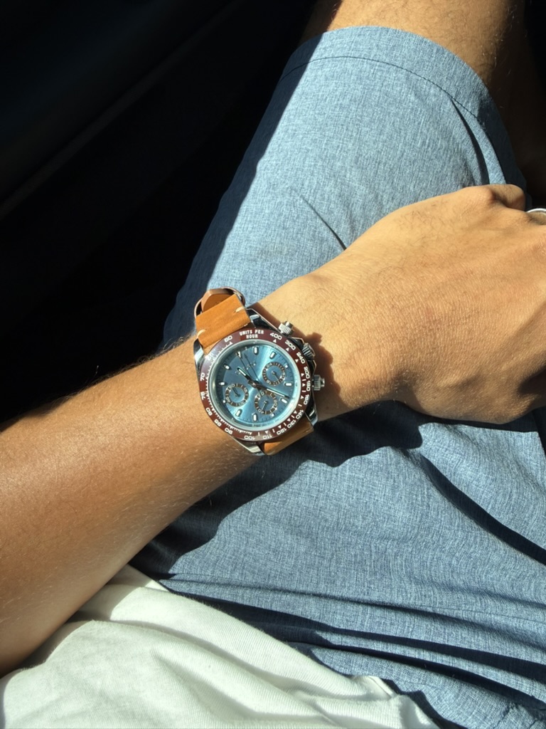 Amber Daytona Homage — worn on the wrist, seated indoors